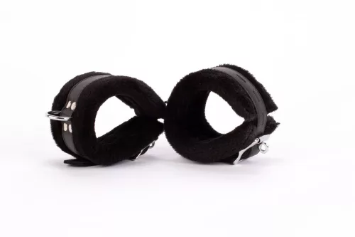 Design delle manette realizzato in pelle morbida per polpacci e pelliccia soffiata nera